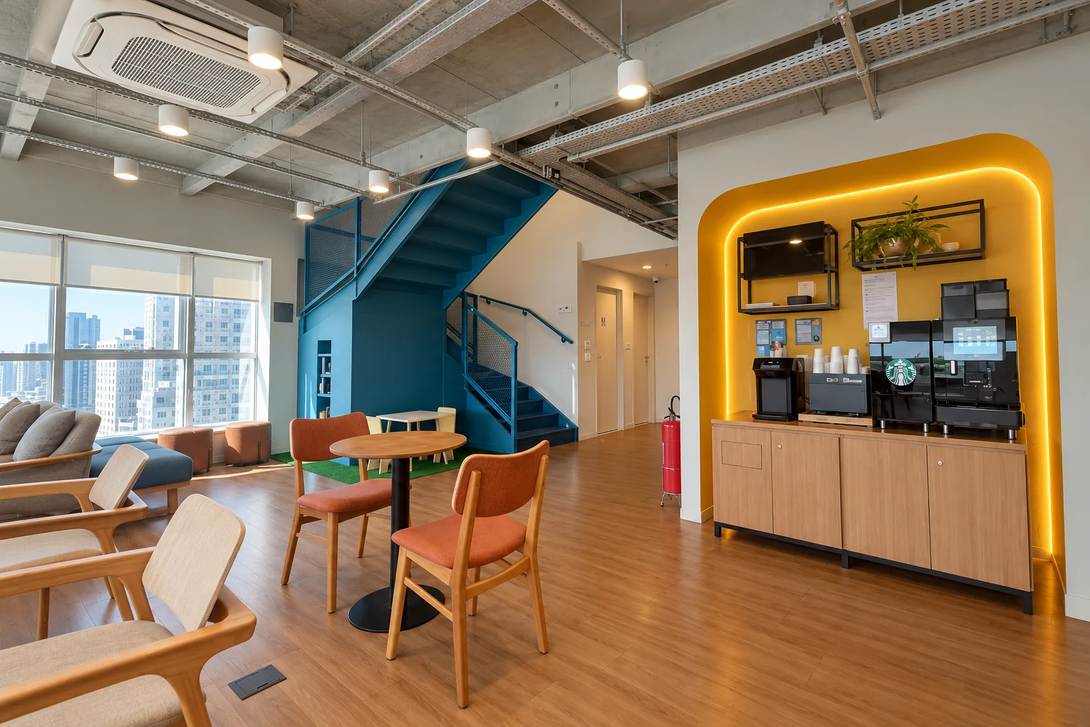 Área de convivência com escada azul e espaço de café.